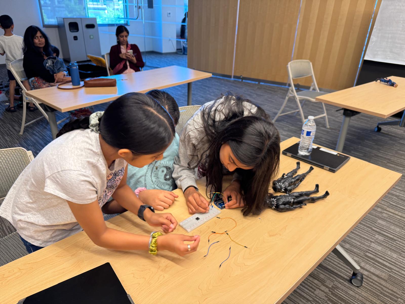 Students collaborate on a hands-on electronics activity during a Girls in Robotics program.